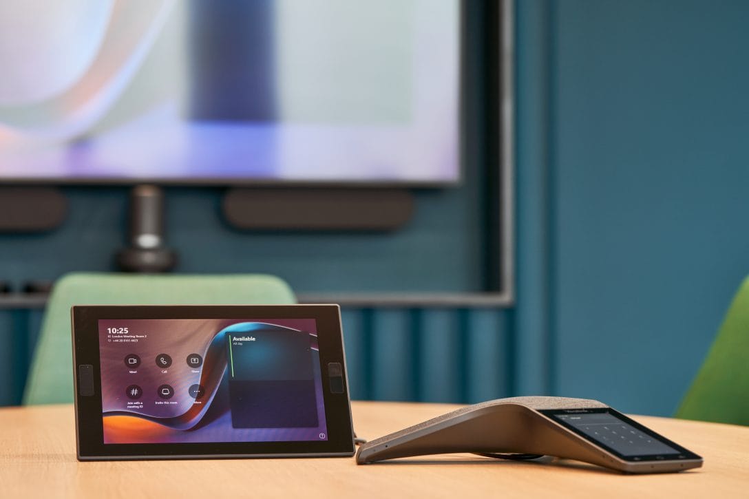 An integrated video conferencing system is showin within a meeting room with optimised office technology.