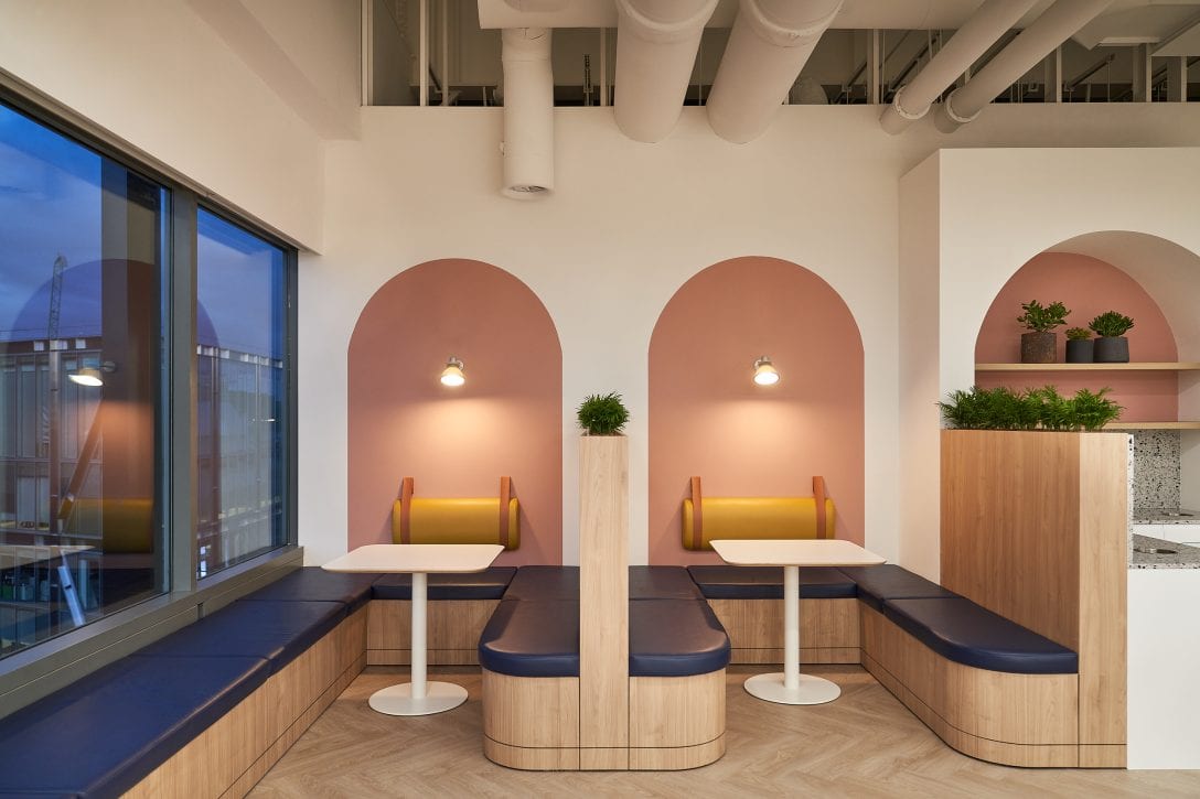 Inside an AIS design and built office two booths are shown inside a staff kitchen area, the spaces are lit with soft lighting giving the space an intimate and private feel.