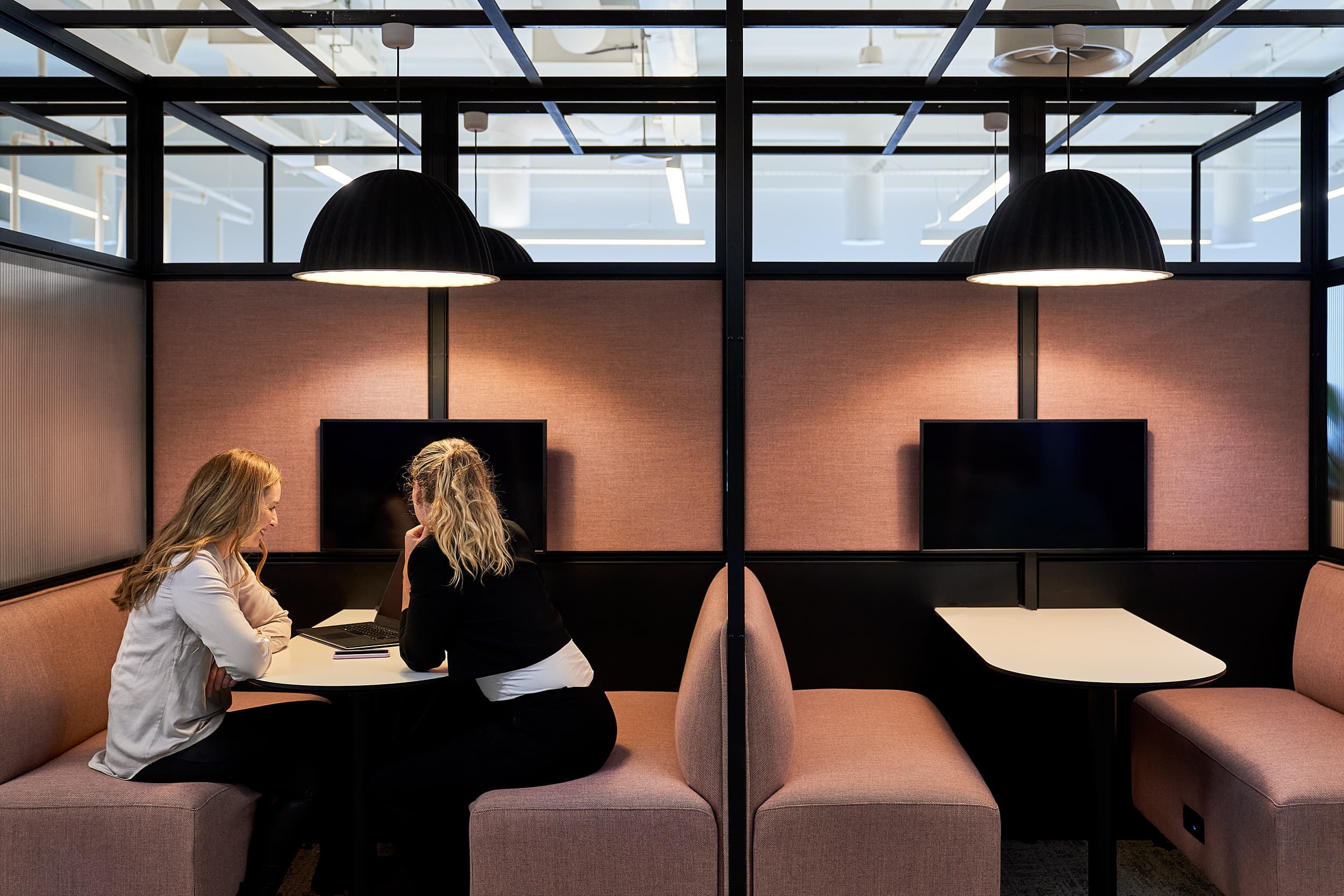 Employees working in a semi-private booth