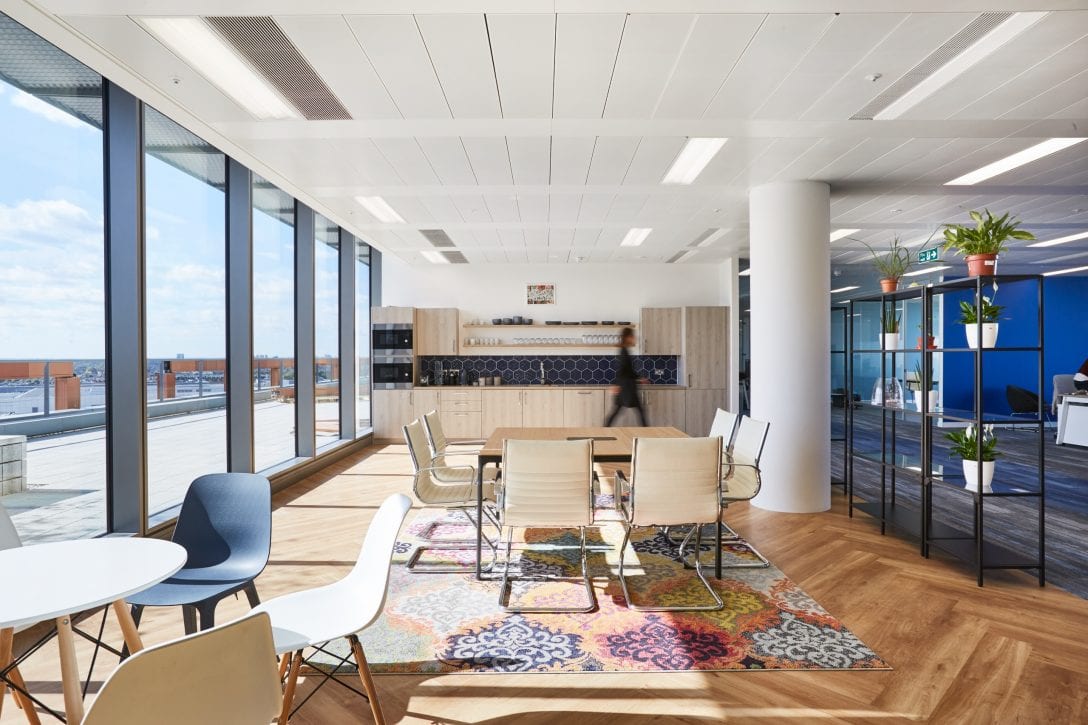 Inside the office of DNA Nudge an employee social space is shown with a teapoint and lots of break out furniture for staff to chill out on breaks. 