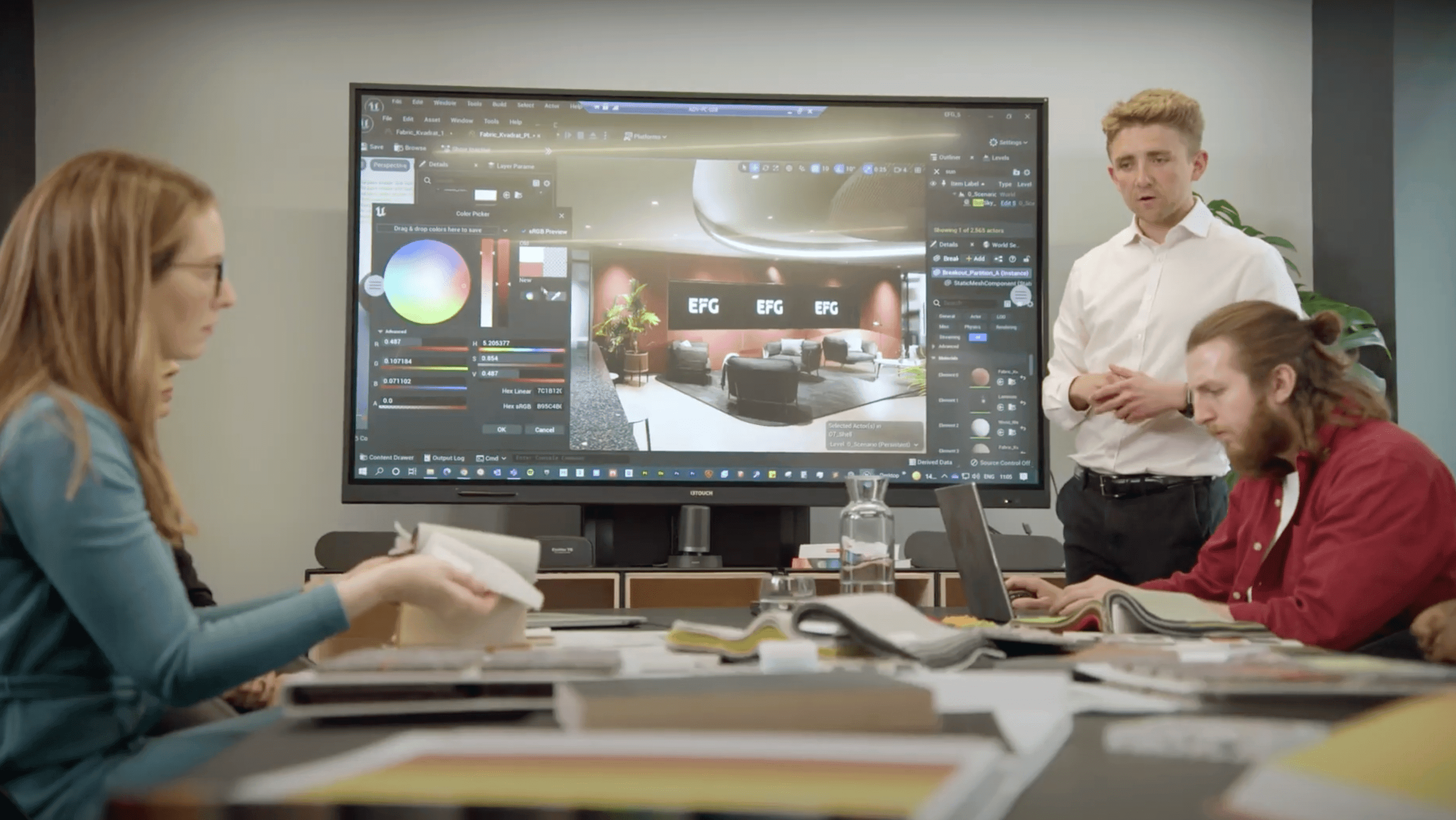 Designers looking at 3D office model