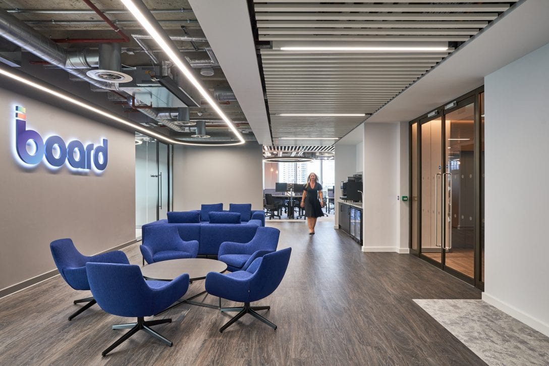 A woman walks through office reception area inside Board MIT offices delivered by AIS.