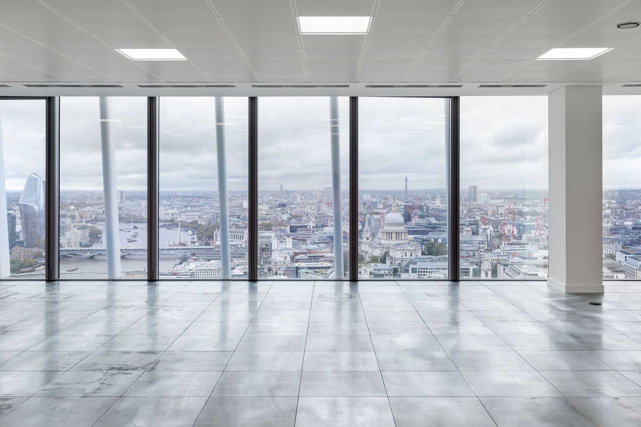 Interior view of a modern office space at 20 Fenchurch Street, featuring large windows with a panoramic view of London, including the River Thames and notable b
