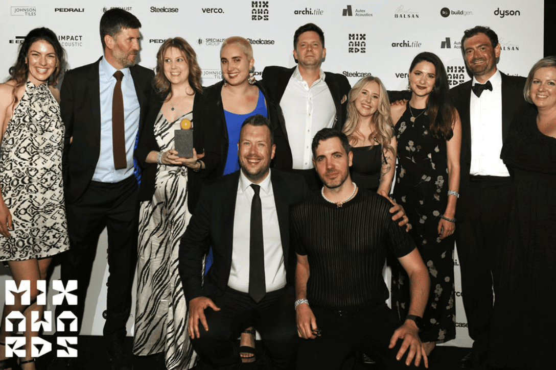 Winners posing and smiling with their award