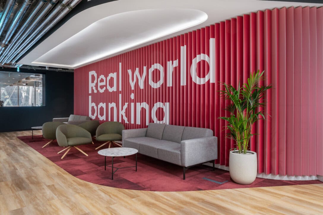 Pink curtain with white text saying real world banking