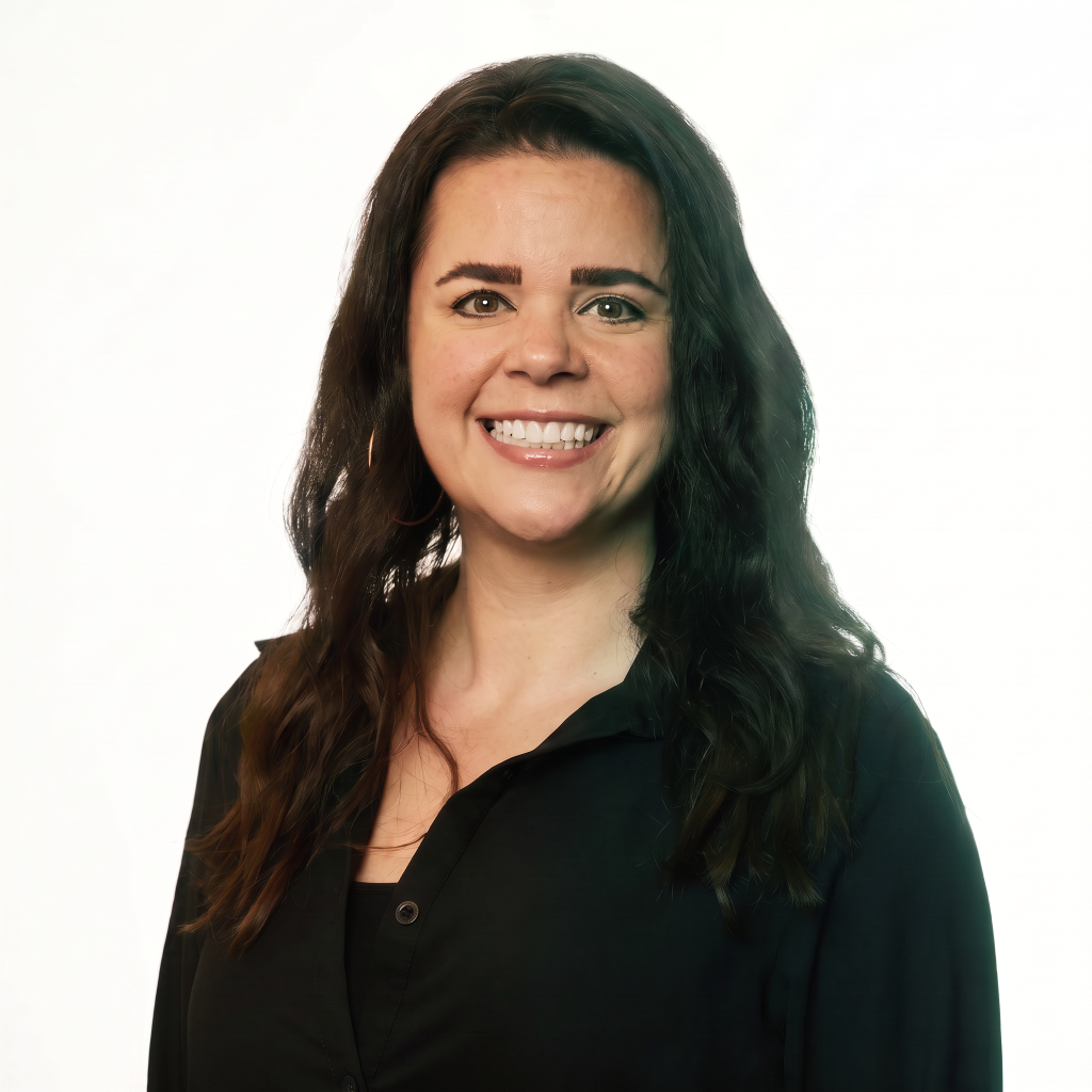 Smiling woman with long, dark hair wearing a black shirt, against a light background.